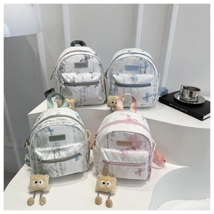 Detailed view of mini nylon backpacks in four colors with butterfly and calligraphy prints