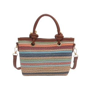 Handwoven straw shoulder bag with multi-color stripes and brown leather handles