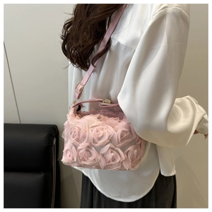 Pink 3D rose flower bag detail showing floral fabric and slim shoulder strap on model