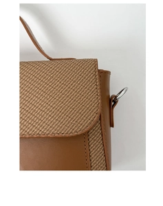 Detail of brown leather and twill fabric patchwork with fine stitching and silver ring