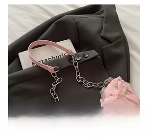 Detail of pink mesh rose petals and mixed chain leather shoulder strap on a handbag