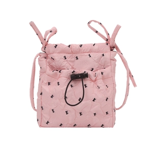 Pink quilted shoulder bag featuring black bow patterns and a drawstring closure