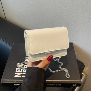 Chic white mini flap bag with crocodile pattern texture and silver chain strap