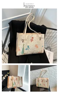 Detail view of cream white embroidered tote bag with traditional koi fish patterns