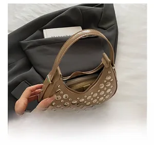 Macro view of interior storage capacity in hobo bag with vintage silver rivets