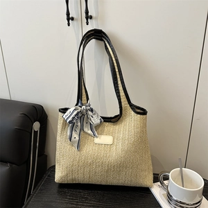 Beige large capacity woven straw tote bag with black leather straps and printed silk scarf