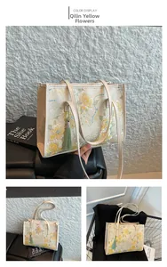 Detailed embroidery and green tassel on a vintage Chinese style cream bucket bag