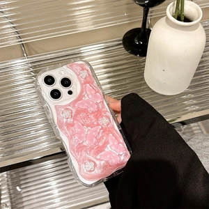 Close-up of pink glitter phone case featuring 3D butterflies and embossed floral details