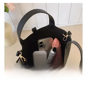 Top view of black lychee leather bucket bag showing large capacity for cosmetics and phone