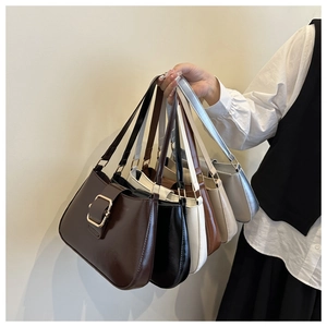 Detail view of colorful faux leather underarm bags with stylish square metal buckles