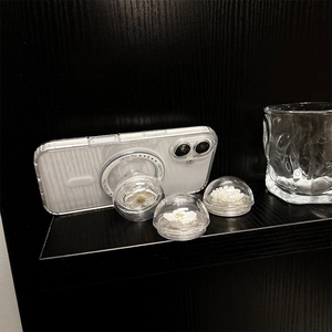 Detail of transparent ball phone grip with pearl flower inside for MagSafe case