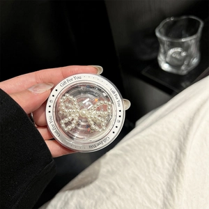 Detail of transparent phone socket with white pearl bow and Gift For You text