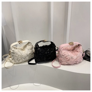 Close-up of 3D chiffon rose flowers texture and metal clasps on elegant mini handbags