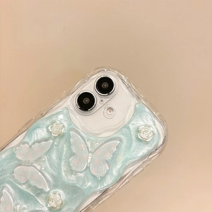 Close-up of glitter butterfly and 3D floral textures on light blue iPhone phone case