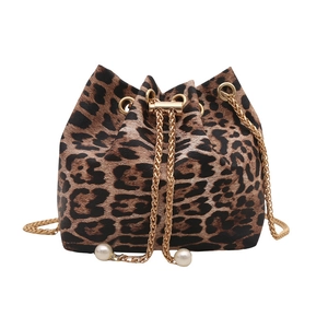 Fashionable leopard print bucket bag with gold chain strap and pearl accents on white background