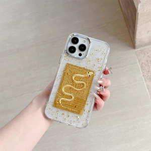 Macro detail of iPhone case featuring gold leaf and 3D embossed golden snake emblem