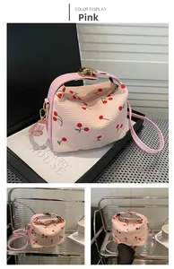 Pink corduroy shoulder bag with red cherry embroidery and elegant gold hardware