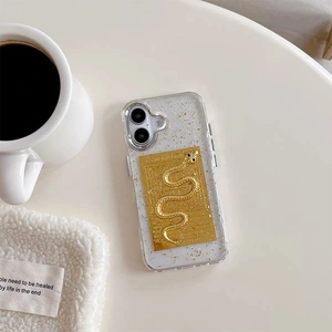Detail of transparent iPhone case featuring 3D gold snake relief and gold foil accents