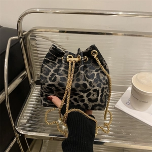 Fashionable leopard print bucket bag with gold chain strap and pearl drawstring charms