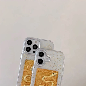 Macro detail of iPhone case with gold foil and embossed golden cobra yantra charm