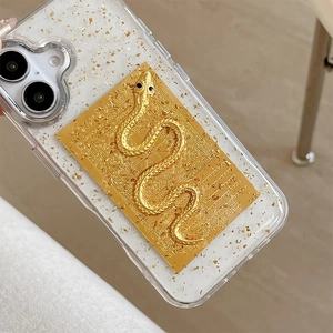 Detail of iPhone case with gold leaf foil and 3D metallic snake emblem on clear resin