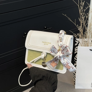 Fashionable white and green contrast crossbody bag with gold lettering and silk handle