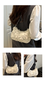 Detailed view of white 3D floral lace texture and silver chain strap on a shoulder bag