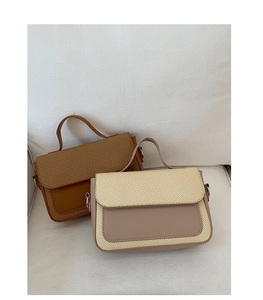 Detail of minimalist leather and straw weave texture on crossbody bag in two colors