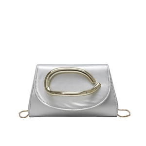 Silver square crossbody bag with oversized gold circular handle and metal chain strap