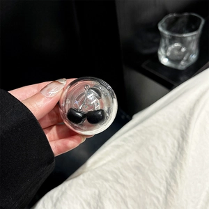 Macro detail of clear resin phone grip featuring glossy black cherry internal charms