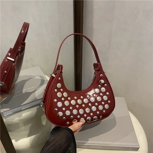 Chic dark red rivet bucket bag with silver studs and polished leather finish