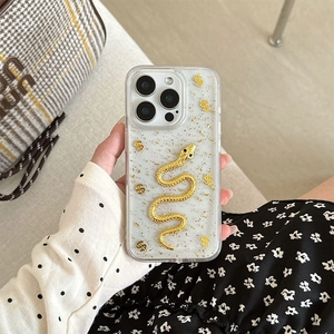 Luxury iPhone case featuring golden foil glitter and a detailed snake emblem design