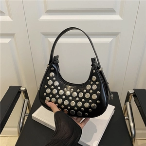 Minimalist black leather hobo bag with silver rivets and sleek half-moon shoulder design