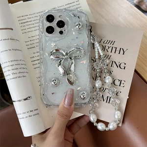 Silver bow iPhone case with luxury pearl and crystal hand strap shown in lifestyle view