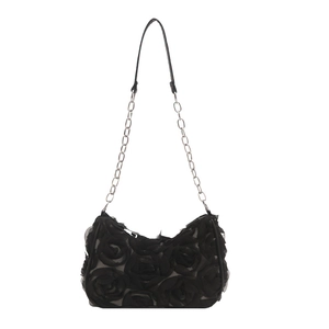 Minimalist black crescent shoulder bag featuring 3D rose lace and metal chain strap