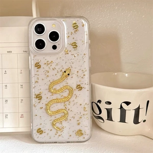 Macro shot of gold foil snake phone case with dollar symbols for iPhone Pro Max model