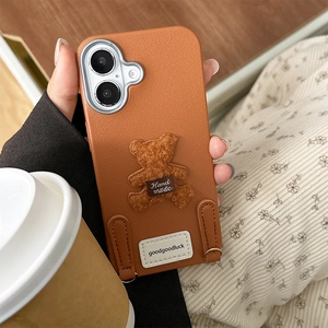 Detail of plush bear on brown lychee texture leather case for iPhone 16 Pro Max