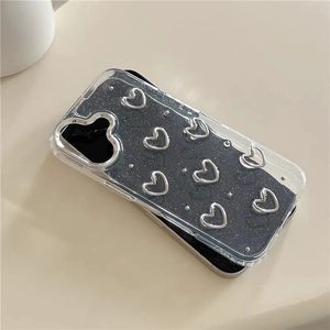 Detail of clear iPhone case with black glitter and silver hollow heart ornaments