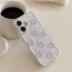 Detail of glitter transparent phone case with 3D silver hearts on a cozy background