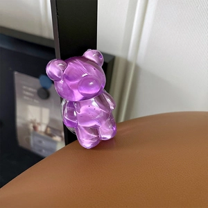 Close-up of a textured purple resin bear-shaped phone grip showing intricate detail