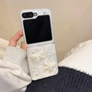 Detail of Galaxy Z Flip phone case with 3D butterflies and pearl accents on cream shell