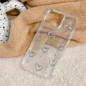 Transparent iPhone case with glitter silver heart patterns and camera ring on plush background