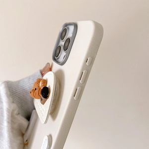 Close-up of litchi leather texture phone case with cute 3D bear and coffee grip