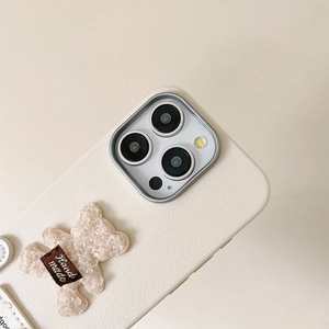 Detailed view of plush bear on cream leather phone case with Hand made label