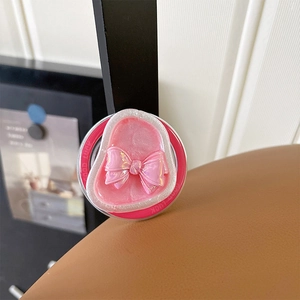 Detail of pink bow phone grip with colorful holographic finish and Good Luck text