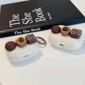 Close-up of AirPods cases with realistic 3D chocolate decorations and hanging ring.