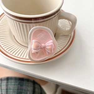 Pink pearl bow retractable phone socket with iridescent resin finish on white desk