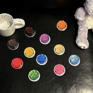 Detail of cute cat paw phone sockets in multiple colors with Good Luck engraving
