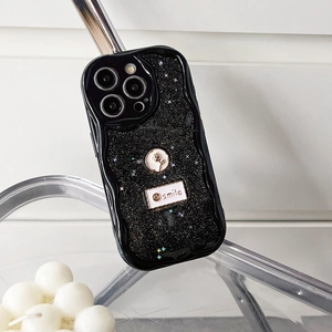Close-up of black glitter phone case with wavy edge and metal rose emblem for iPhone