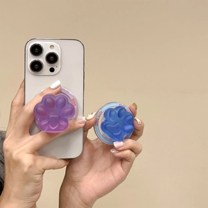 Detail of matte blue and purple cat paw phone grips featuring good luck text